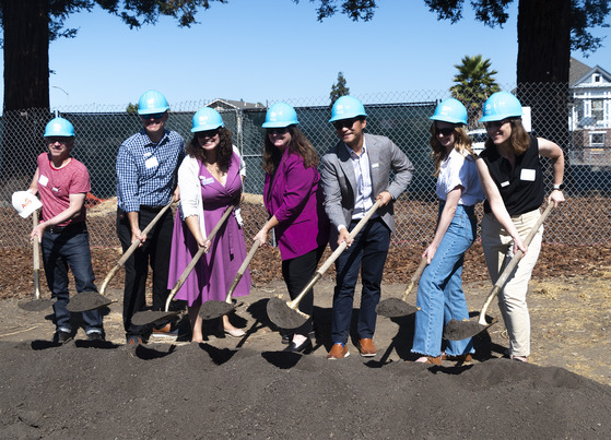 Ava staff shoveling dirt at the groundbreaking event