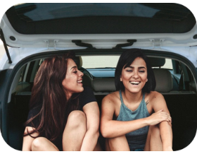 EV Assistant - image of two women sitting and smiling in an EV