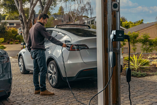 NeoCharge image of person plugging in EV