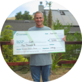 Curt, Gilroy Resident, with Electric Showcase Award check