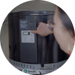 an image of a woman adjusting their heat pump water heater