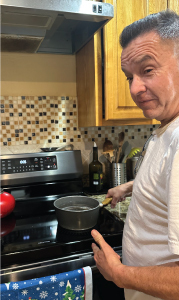 Photo: Abel Melendrez cooking on the family’s new electric induction stove