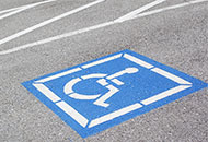 Photo of handicapped symbol painted on a parking space. 