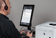 man sitting at voting screen holding controller pad to vote