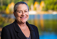 supervisor jennifer montgomery smiling and standing by a lake