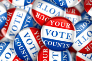 Image of red, white and blue buttons that read "your vote matters". 