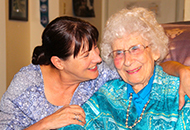 Photo of an elderly woman with a younger woman. 