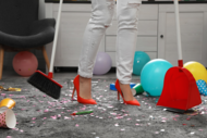 Photo of woman cleaning up after a party.