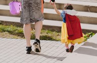 Toddler walking with an adult