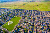 Aerial photograph of new housing development bounded by undeveloped land