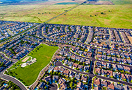 Ariel view of homes next to an open field