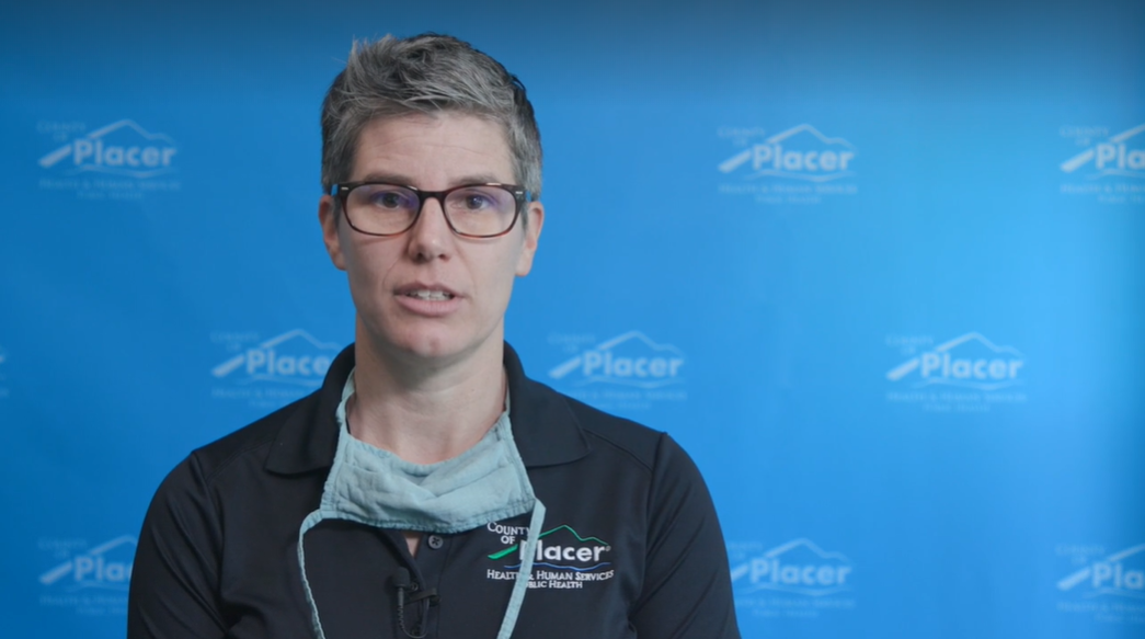 null Dr. Aimee Sisson standing in front of a blue background