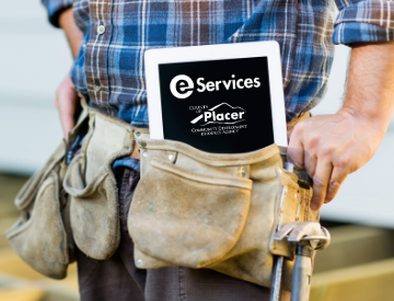 man with tool belt hold a tablet computer