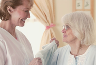elderly women being cared for by younger woman