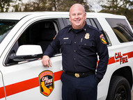 Portrait of CAL FIRE NEU Unit Chief / Placer County Fire Department Chief Brian Estes in front of fire vehicle 