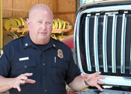 CAL FIRE Nevada Yuba Placer Unit Chief Brian Estes stands in front a fire engine