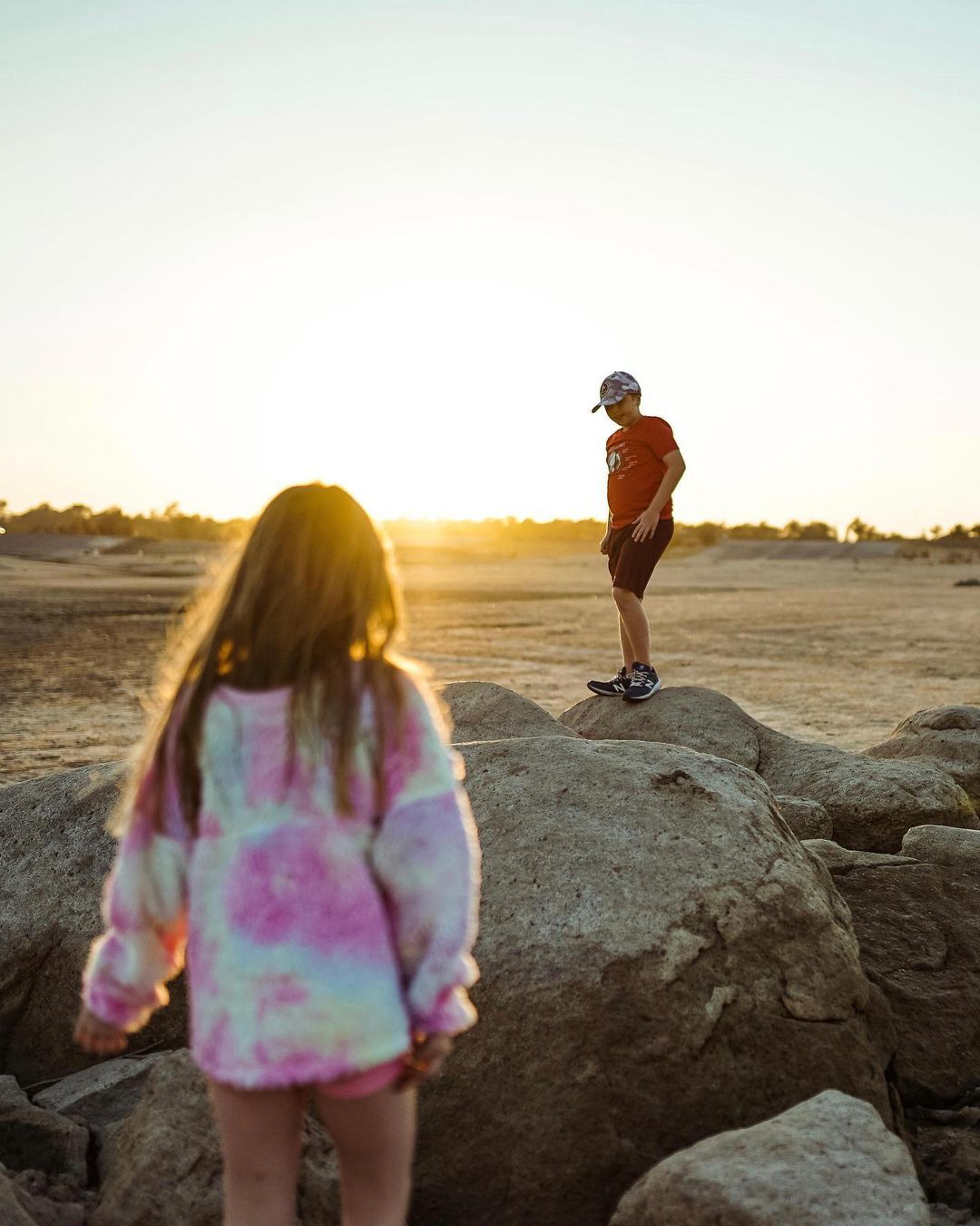 Photo of a child and parent at sunset. 