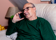 Photo of an older man on the phone. 