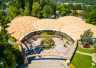 Aerial photograph of domed-shape office building surrounded by trees