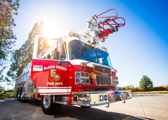 A gleaming fire truck with side door open