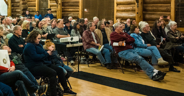 Community members gather for a meeting in a lodge hall
