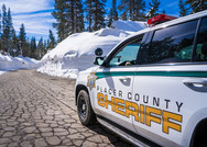 Placer County Sheriff's Office patrol vehicle driving a snowy mountain road