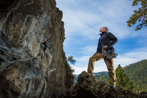 man looking giant rock wall