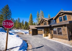 Snowy duplex behind a stop sign