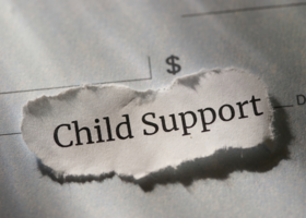 Child Support text on paper with dollar signs