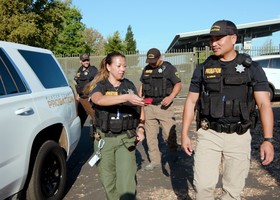Female and male Placer County probation dept. officers walking together 