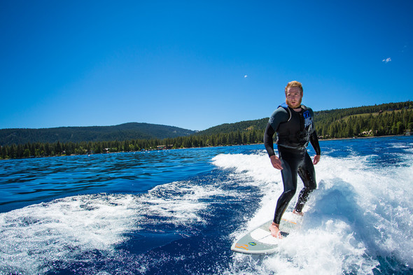 Young man waterski surfing in Lake Tahoe