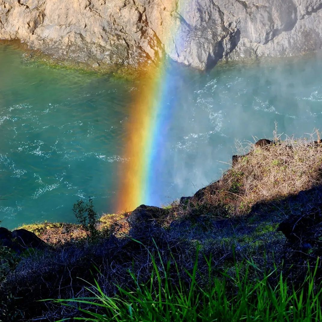 instagram image of a rainbow over a river