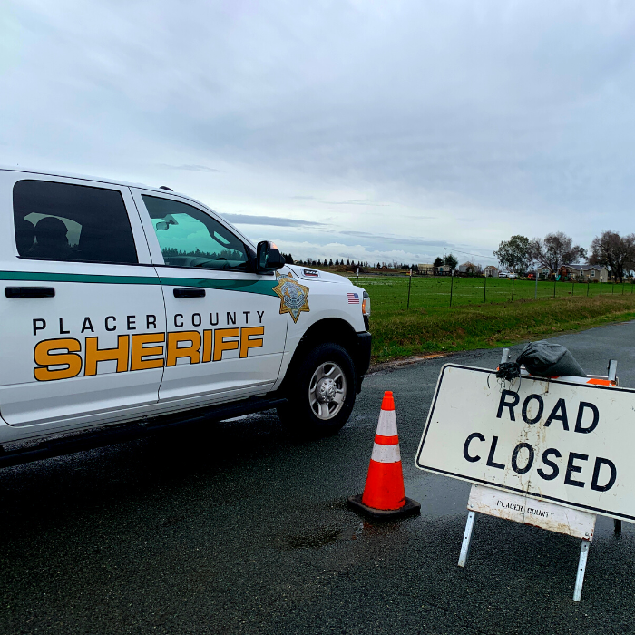 Placer County Sheriff's Office SUV at a road closed sign