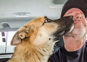Officer Dan gets a kiss from a pooch