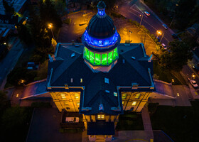 Drone shot of courthouse lit blue and green