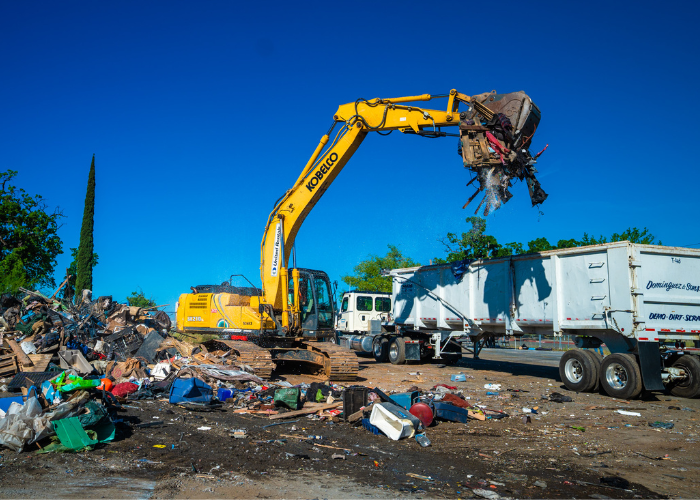 Heavy machinery cleaning up remains from a closed homeless encampment