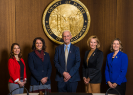 Board of Supervisors stand in front of Placer County seal