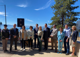 Local and national leaders stand in front of Lake Tahoe 