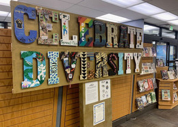 Colorfully patterned, wooden letters spell out "Celebrate Diversity" on library wall