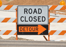 Road Closed Detour sign on street