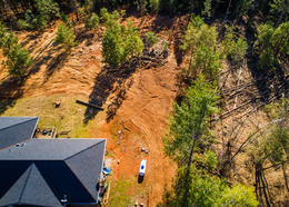 Foothills home in a clearing surrounded by trees