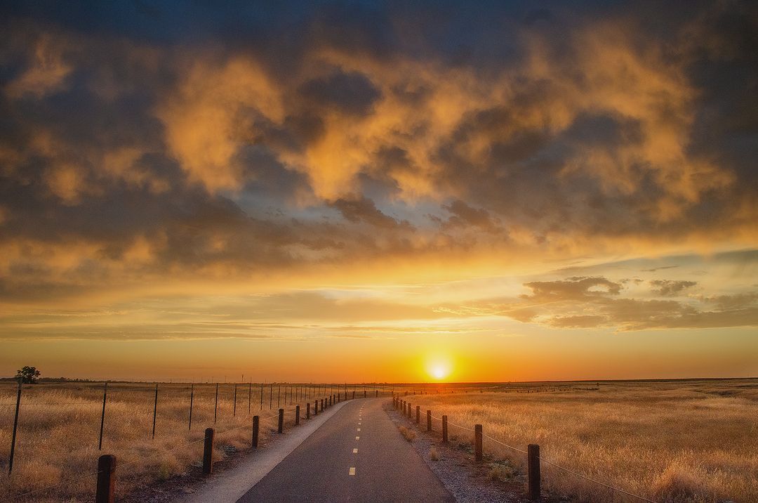 Roseville sunset over road and open field