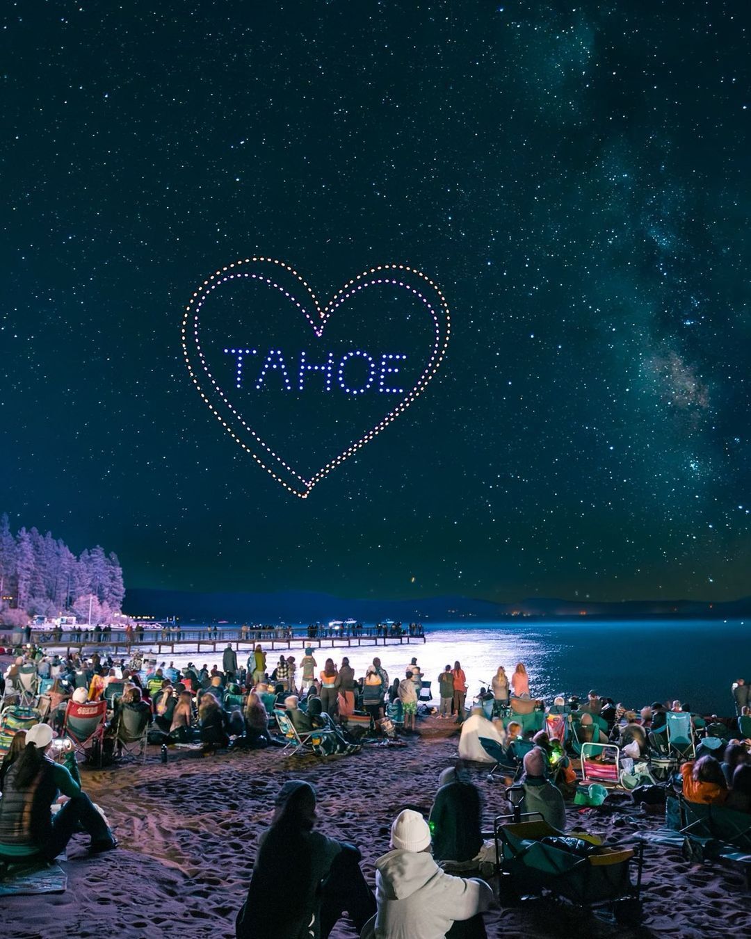 Drones form a heart around the word "Tahoe"  during a nighttime drone show at Kings Beach