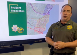 Placer County's Lieutenant Conners stands before charts showing county evacuation zones