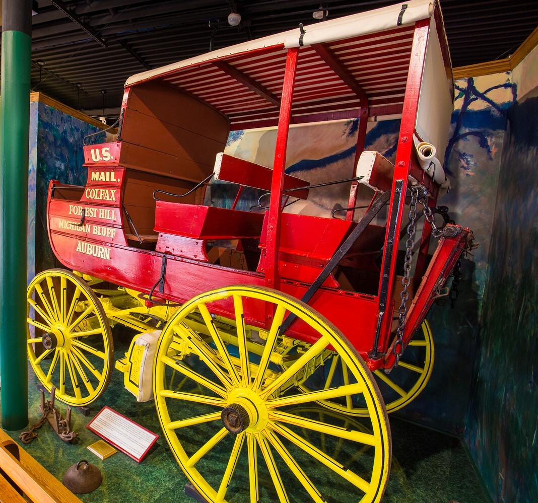 Auburn-Forest Hill stagecoach with vibrant red body and yellow wheels