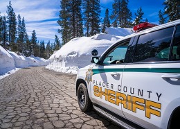 Placer County Sheriff patrol vehicle drives on snow plowed road