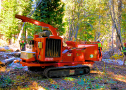 Workers use heavy equipment to reduce wildfire fuel loads
