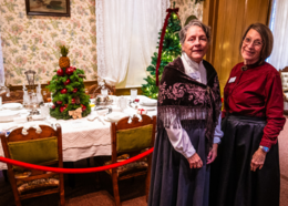 Placer County museum staff pose in front of holiday-themed display