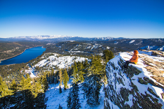 Person sits for a break on the edge of Donner Peak