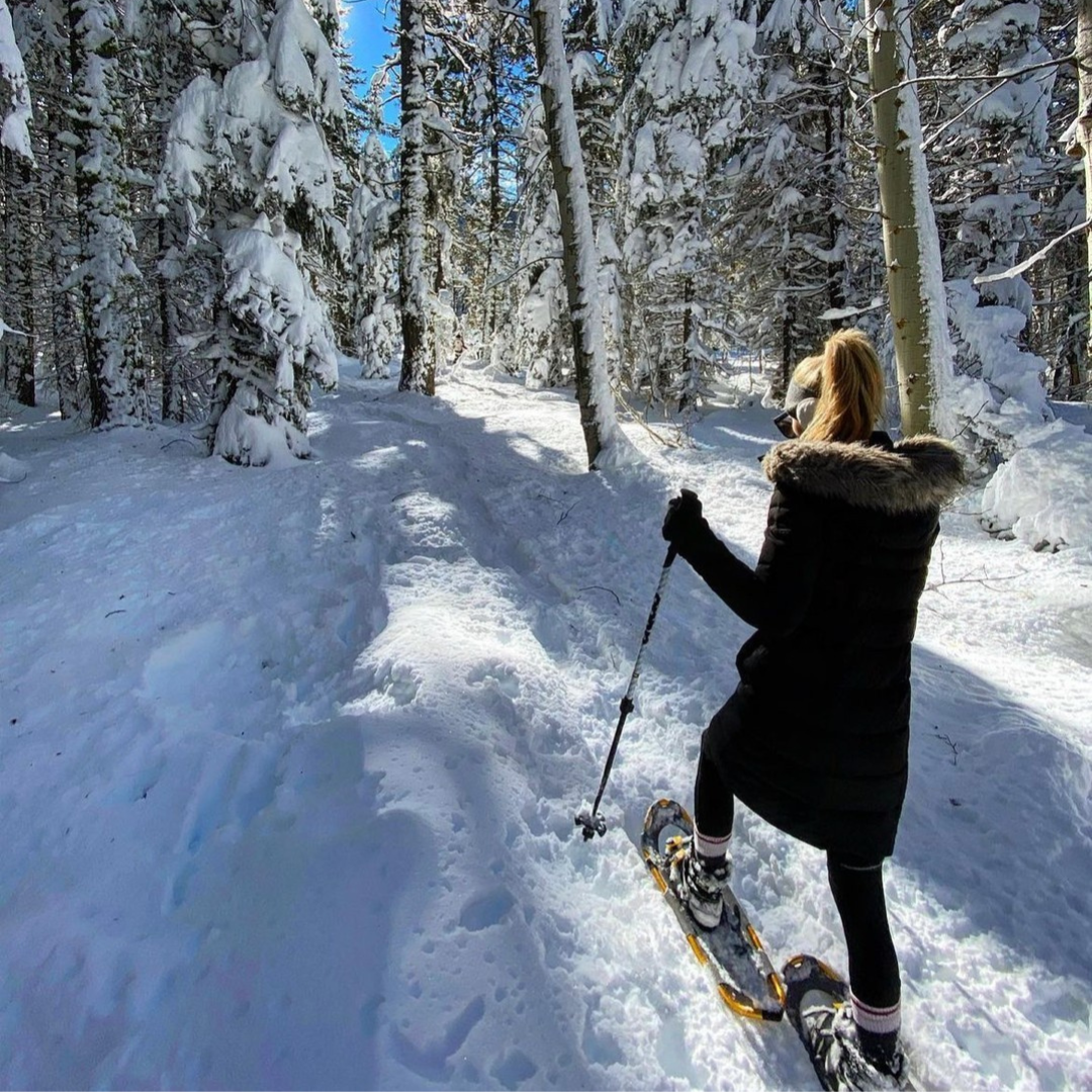 Woman snowshoeing in the woods of North Lake Tahoe